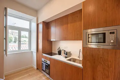 a kitchen with a sink and a microwave at Superb Flat w Balcony and AC by LovelyStay in Porto