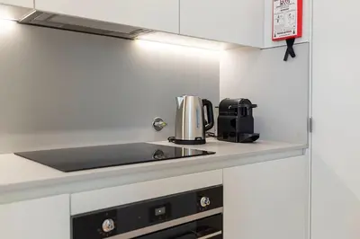 a kitchen with a sink and a coffee maker on a counter at Scenic River-View T1 by Lisbeyond in Vila Nova de Gaia