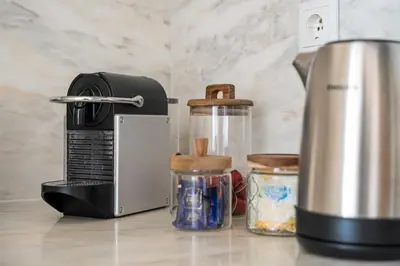 a kitchen counter with a coffee maker and jars at GuestReady - Explore Porto from a prime location in Porto