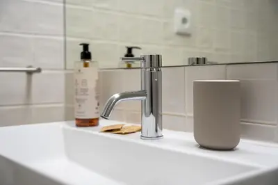 a bathroom sink with a faucet and a cup on it at GuestReady - Explore Porto from a prime location in Porto
