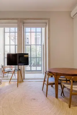 a living room with a table and a flat screen tv at Almada 151 - 1T in Porto
