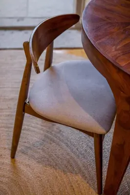 a wooden chair sitting next to a wooden table at Almada 151 - 1T in Porto