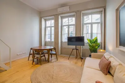 a living room with a couch and a table at Almada 151 - 2F in Porto