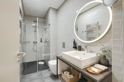 a bathroom with a sink and a shower and a mirror at Republica 144 Apartamentos by DA'Home in Porto