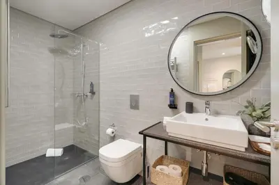 a bathroom with a sink toilet and a mirror at Republica 144 Apartamentos by DA'Home in Porto