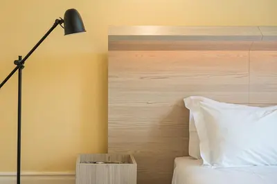a bedroom with a bed with a lamp and a headboard at GuestReady - Vereda Downtown Apartments in Porto