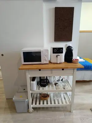 a microwave on top of a table in a room at Porto Alma 388 - Silent city center in Porto