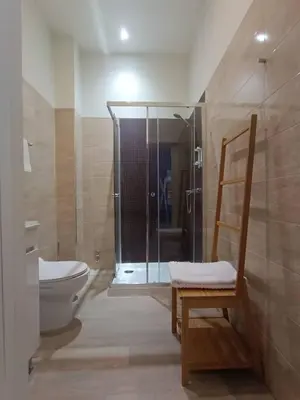 a bathroom with a shower and a toilet and a chair at Porto Alma 388 - Silent city center in Porto