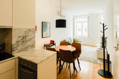 a kitchen and dining room with a table and chairs at PortoCenter METRO Marquis Cozy apartment in Porto