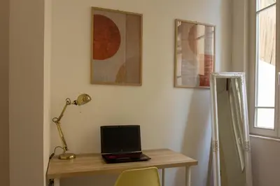 a desk with a laptop computer on top of it at T2 Pedra do Bonfim, Centro do Porto com Pátio e Churrasqueira in Porto