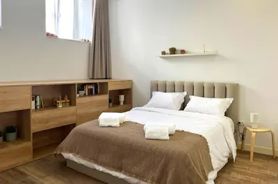 a bedroom with a bed with two pillows on it at T2 Pedra do Bonfim, Centro do Porto com Pátio e Churrasqueira in Porto