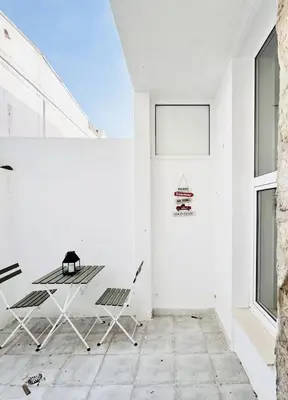a room with white walls and a table and chairs at Porto Boavista Patio House in Porto