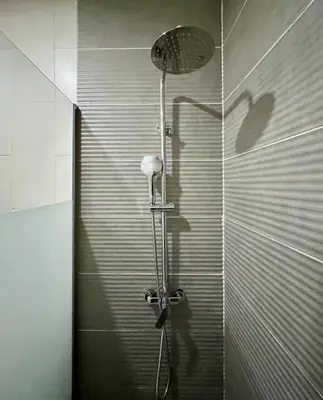 a shower stall with a shower head in a bathroom at Porto Boavista Patio House in Porto