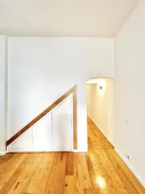 an empty room with a wooden floor and white walls at Porto Boavista Patio House in Porto