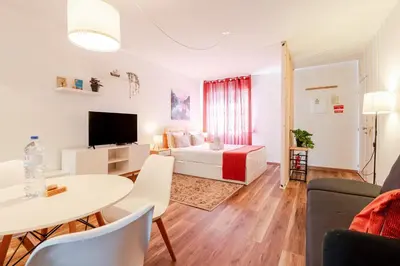 a living room with a bed and a table at NEW! Gaia Arrabida in Vila Nova de Gaia