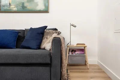 a living room with a gray couch and a side table at GuestReady - Fantastic Porto Flat in Porto