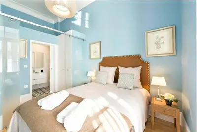 a bedroom with a large bed with blue walls at Wine Cellar by Upperground in Porto