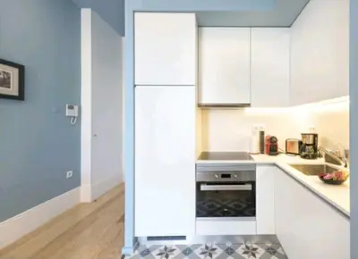 a kitchen with white cabinets and a refrigerator at Wine Cellar by Upperground in Porto