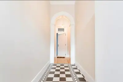 a hallway with a black and white checkered floor at Wine Cellar by Upperground in Porto