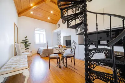 a room with a spiral staircase and a dining room at Cozy Stay w/ AC and View in Porto