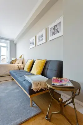 a living room with a blue couch and a table at Historical Corner by Upperground in Porto