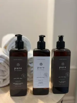 three bottles oficating products sitting on a table at Heart of Porto by Upperground in Porto