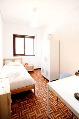 a bedroom with a bed and a desk and a table at Baron Omega in Porto