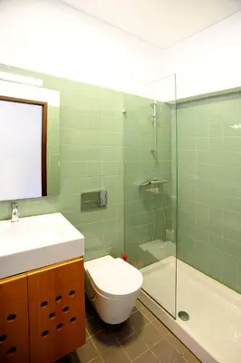 a bathroom with a toilet and a glass shower at Baron Omega in Porto