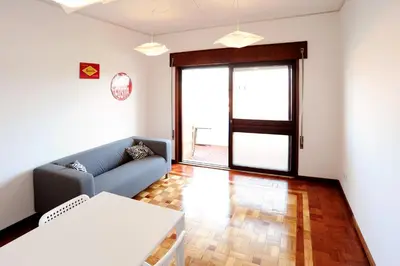 a living room with a couch and a table at Omega White in Porto