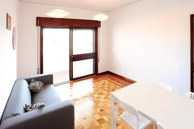 a living room with a couch and a table at Omega White in Porto