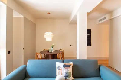 a living room with a blue couch and a table at Catarina 392 by LovelyStay in Porto