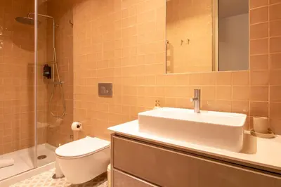 a bathroom with a sink and a toilet and a shower at Catarina 392 by LovelyStay in Porto