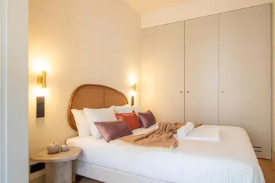 a bedroom with a large white bed with colorful pillows at Catarina 392 by LovelyStay in Porto