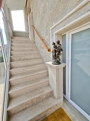 a staircase with a statue next to a door at Well at Home in Vila Nova de Gaia