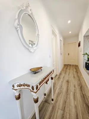 a room with a table and a mirror on the wall at Well at Home in Vila Nova de Gaia