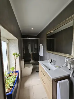 a bathroom with a sink and a toilet and a mirror at Well at Home in Vila Nova de Gaia