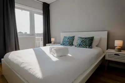 a bedroom with a large white bed with a window at 3BR Flat by Casa da Música, Central, Sleeps 6, E in Porto