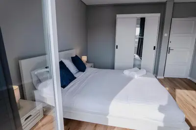 a bedroom with a white bed and a mirror at 3BR Flat by Casa da Música, Central, Sleeps 6, E in Porto