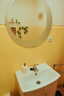 a bathroom with a sink and a mirror at Sailor's House 3 - Casa dos Bibos in Porto