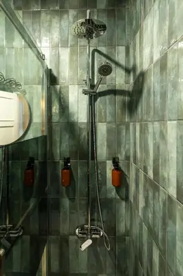 a shower in a bathroom with green tiled walls at 3BR Flat by Casa da Música, Central, Sleeps 6, 2D in Porto
