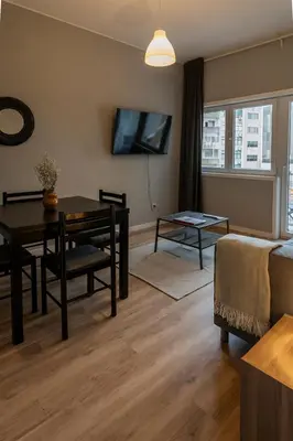 a living room with a dining room table and a couch at 3BR Flat by Casa da Música, Central, Sleeps 6, 2D in Porto