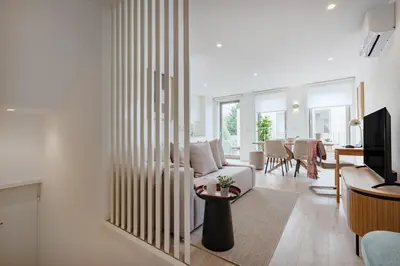 a bedroom with two beds and a large window at The Light Loft @ BoaVista Flats in Porto