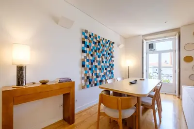 a dining room with a table and chairs and a window at Porto Cedofeita Urban Charm Residence in Porto
