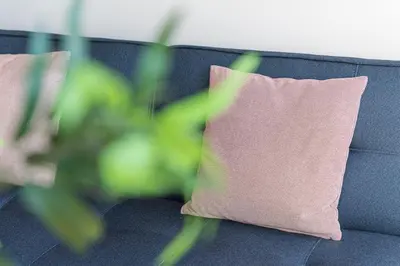 a blue couch with a pink pillow on it at Candy Crush in Porto