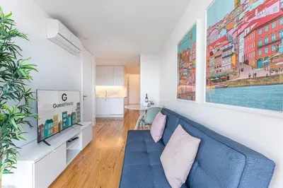 a living room with a blue couch and a table at Candy Crush in Porto
