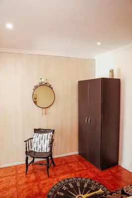 a room with a chair and a mirror and a cabinet at Sailor's House - Holiday's House in Porto