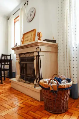 a living room with a fireplace and a basket on the floor at Sailor's House - Holiday's House in Porto