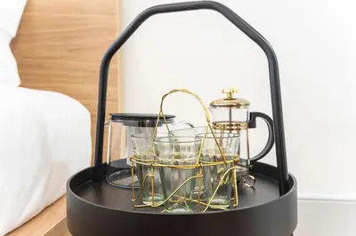 a black lantern with glasses on a table at Modern Retro Downtown by LovelyStay in Porto