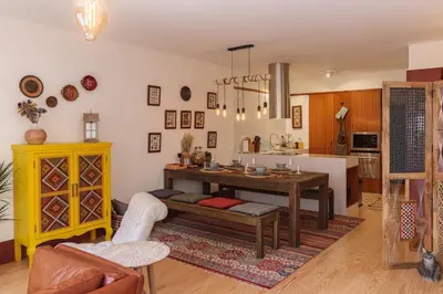 a living room with a table and a kitchen at Garden of Eden - 2 bdrs, elevator, AC and terrace in Porto