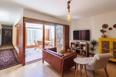 a living room with a couch and a chair at Garden of Eden - 2 bdrs, elevator, AC and terrace in Porto